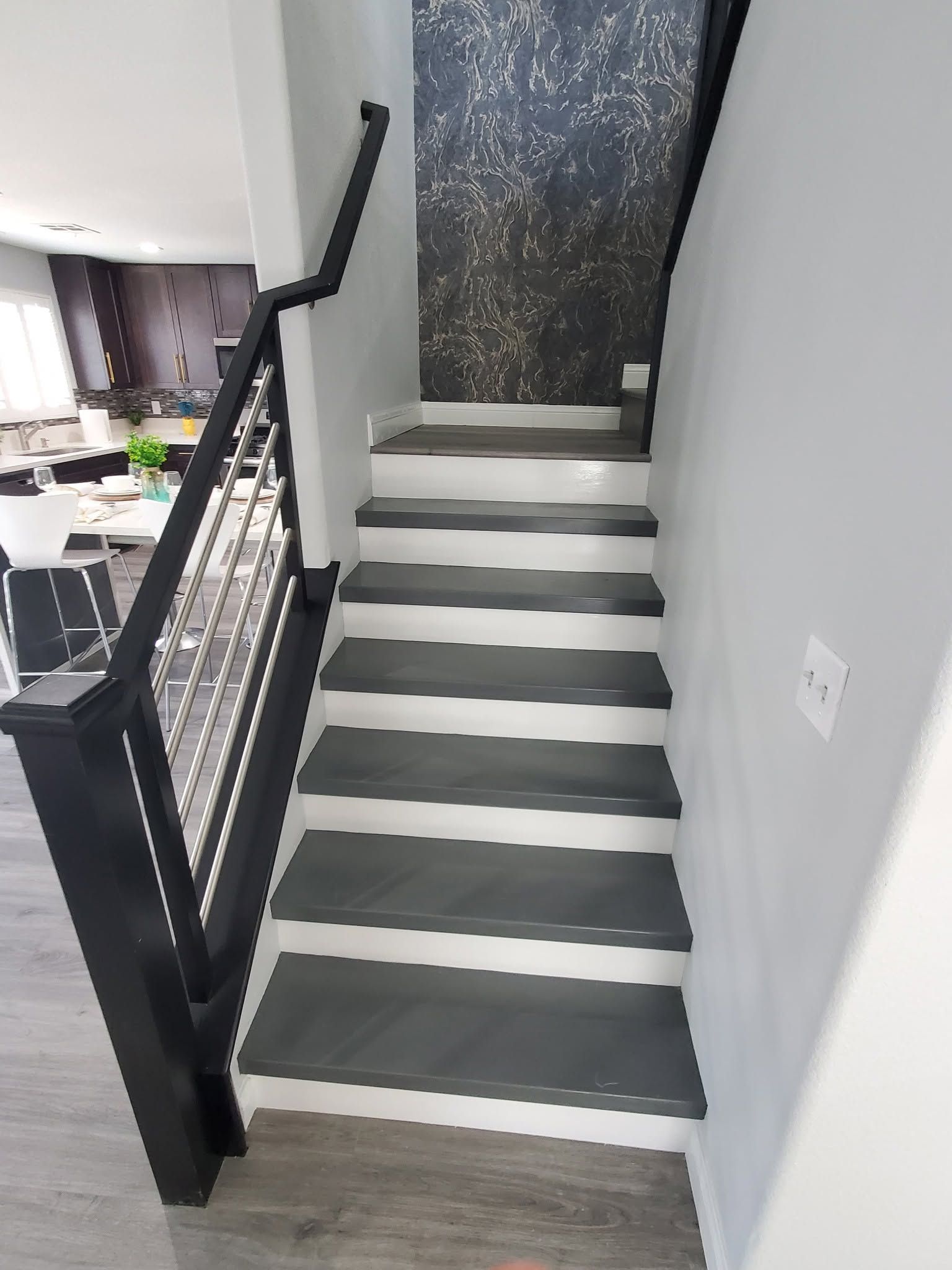 Painted stairs gray and railing black in Ankeny, Iowa.