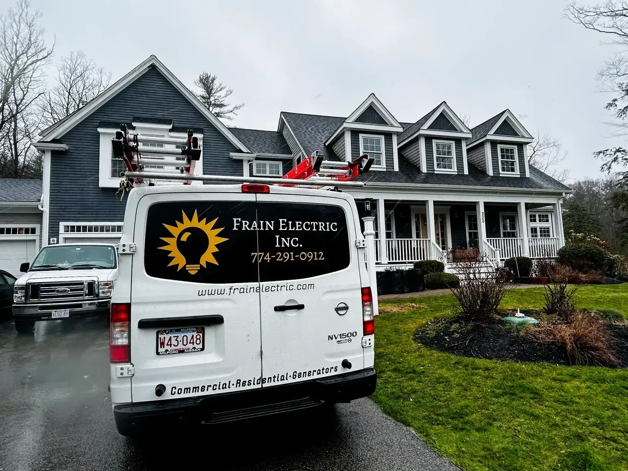 White van with Frair Electric logo parked in front of a house.