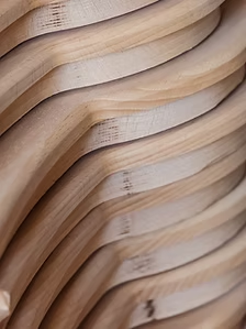 Wooden structure with layered, undulating waves.