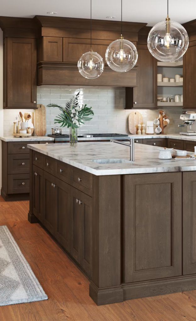 Modern kitchen with dark brown cabinets, a white countertop, and three pendant lights.