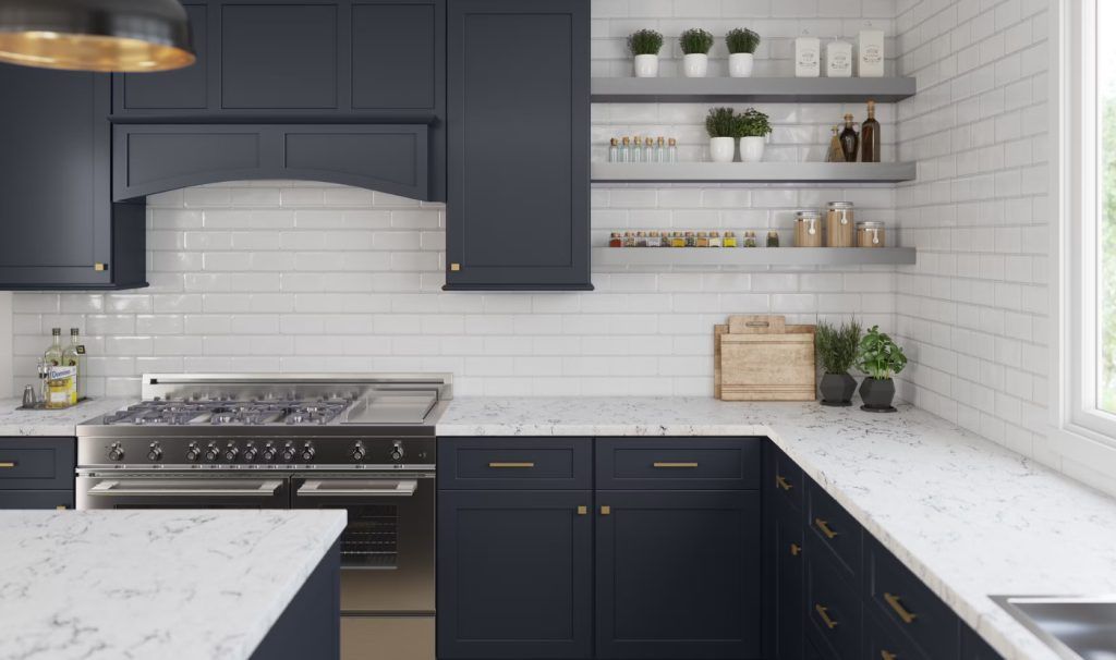 Navy kitchen with white countertops and subway tile backsplash.