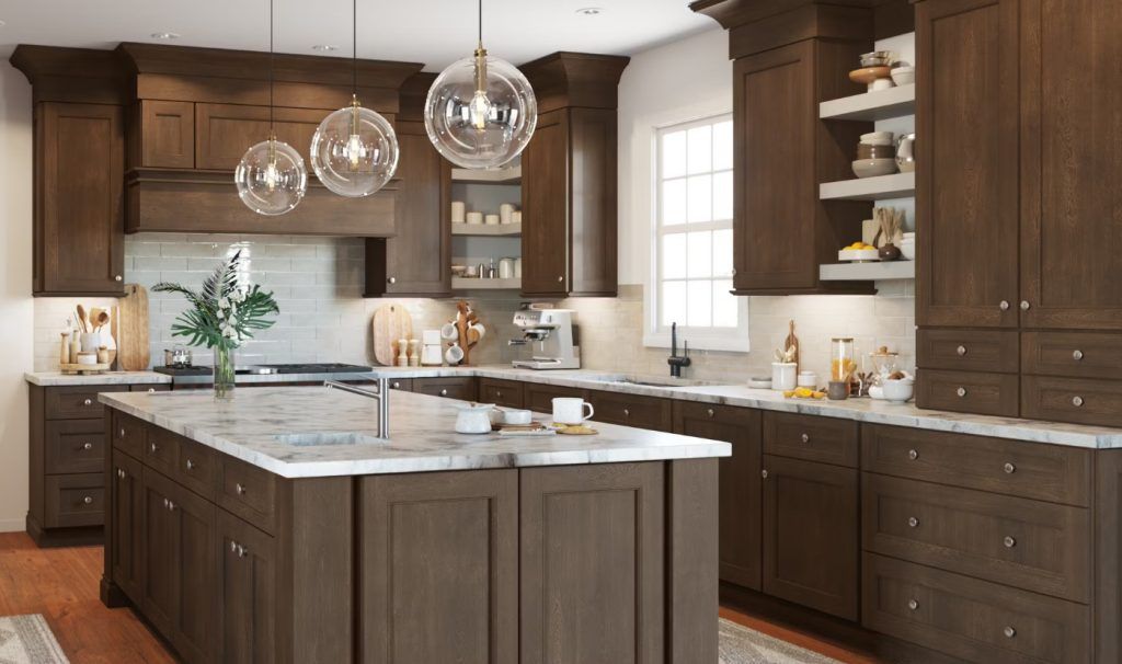 Brown kitchen with island, marble countertops, pendant lights, and wooden cabinets.