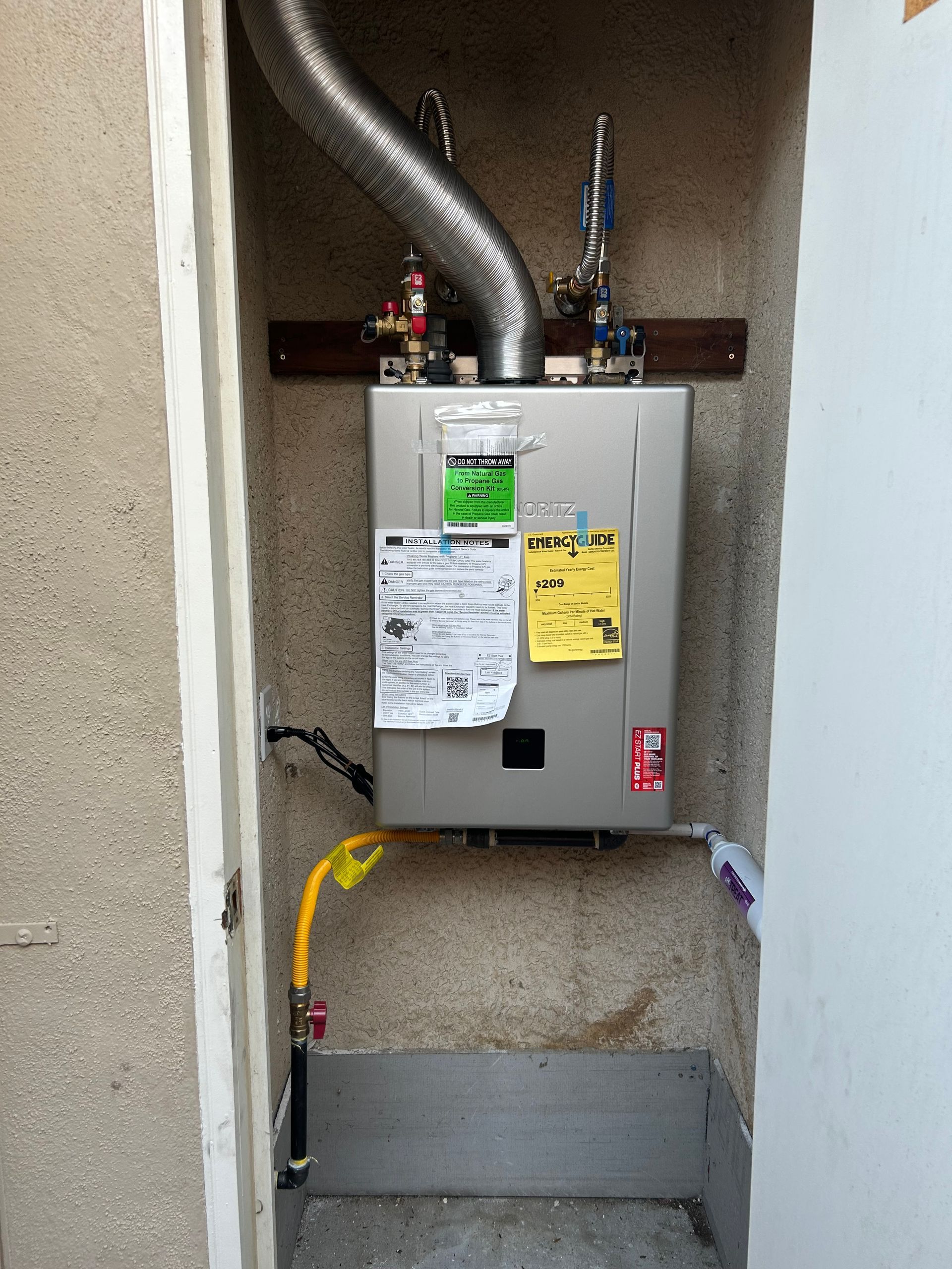 Laundry closet with a furnace unit, vents, and posted maintenance notices