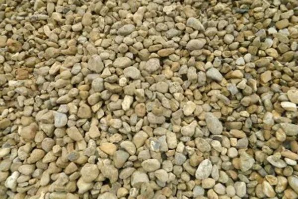 A pile of gravel is sitting on the ground.