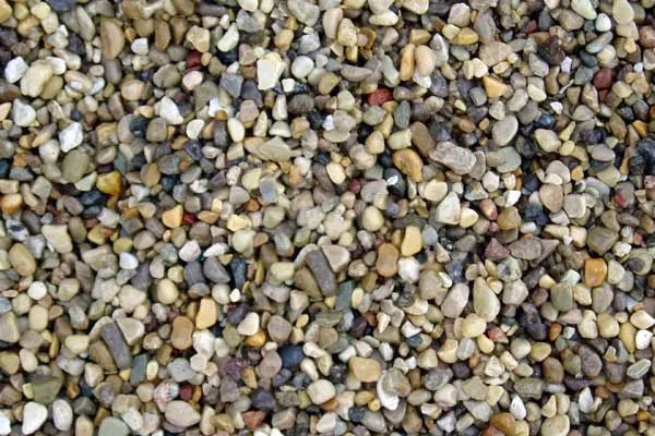 A pile of small rocks of different colors and sizes