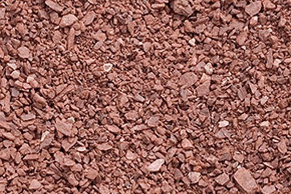 A close up of a pile of brown gravel.