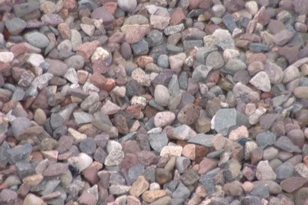 A pile of rocks is sitting on the ground.