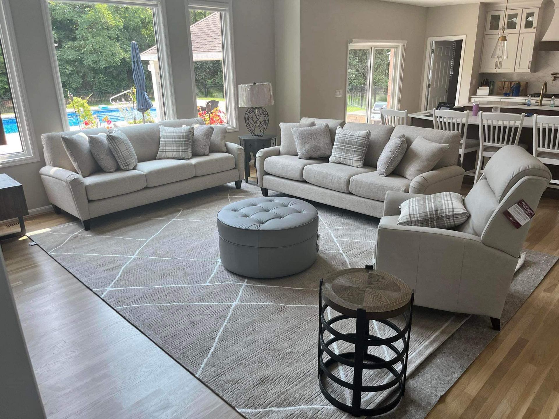 A living room filled with furniture and a rug.