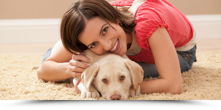 Dog and woman on carpet