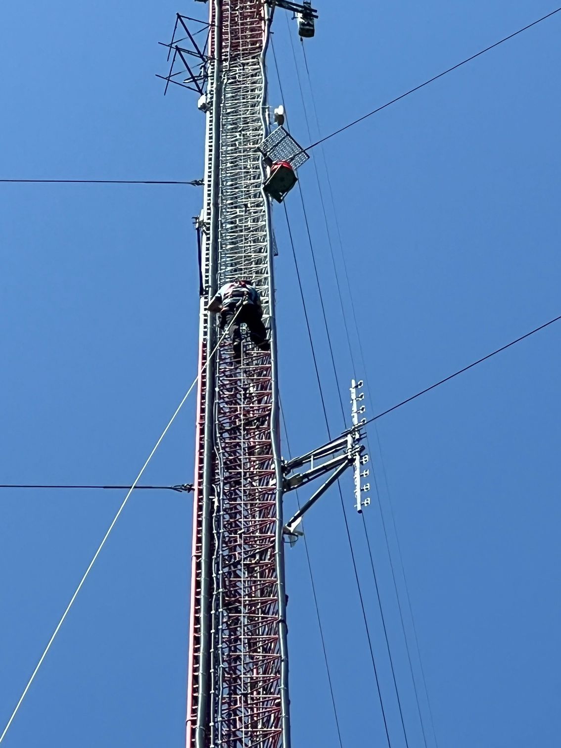 A telephone pole with a blue sky in the background