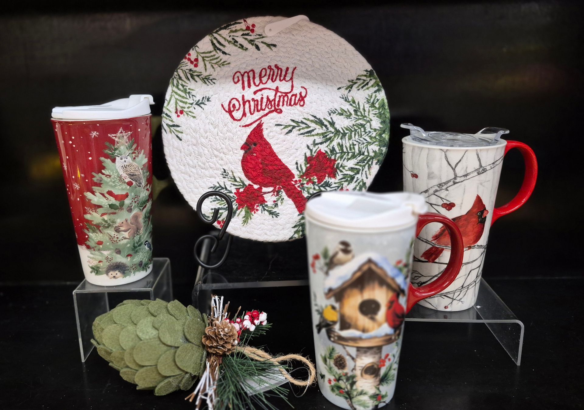Christmas decor: Cardinal-themed plate, travel mugs, and ornaments.