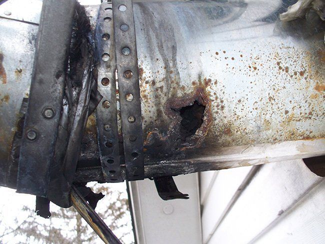 A piece of rusty metal with holes in it