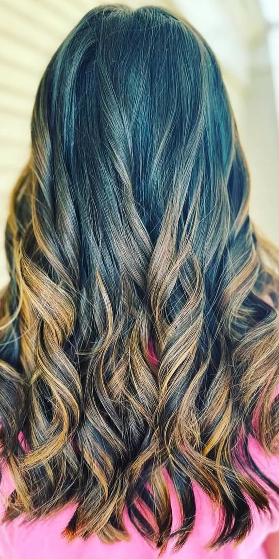 Woman with dark hair with ombre light brown curls