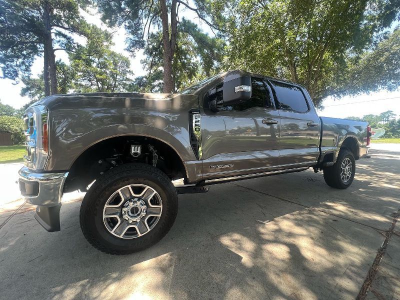 A gray pickup truck is parked on the side of the road.