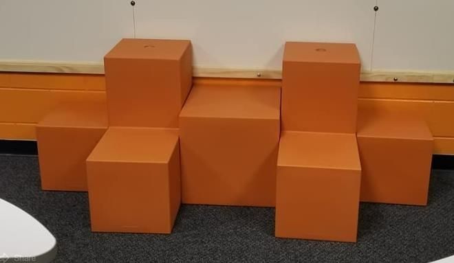 Orange blocks arranged against a wall, forming a step-like structure.
