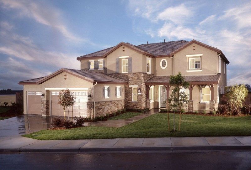 A large house with a lot of windows and a garage