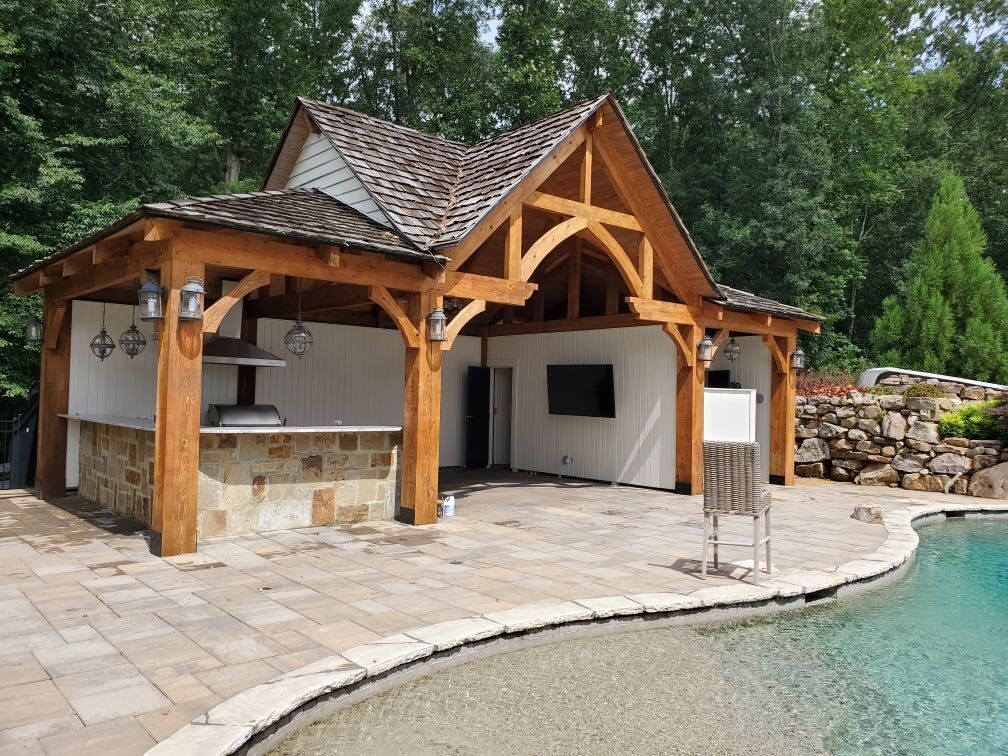 A large house with a swimming pool in front of it