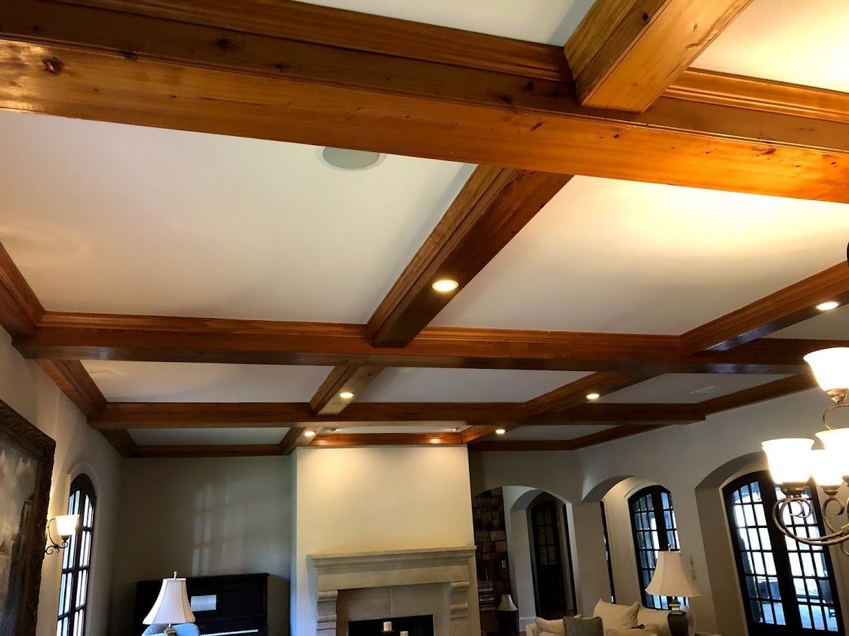 A living room with wooden beams and a fireplace