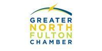 Logo of the Greater North Fulton Chamber, with blue, yellow and green text and a curved line with a lightning bolt.