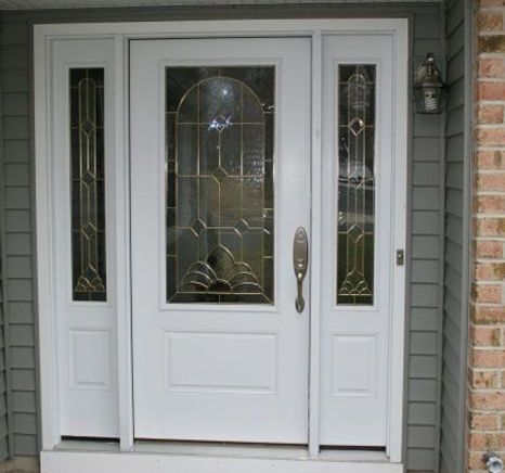 A white front door with a stained glass window