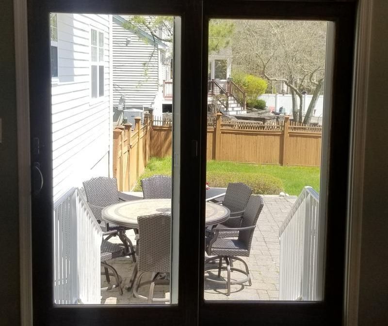 A living room with a sliding glass door leading to a patio
