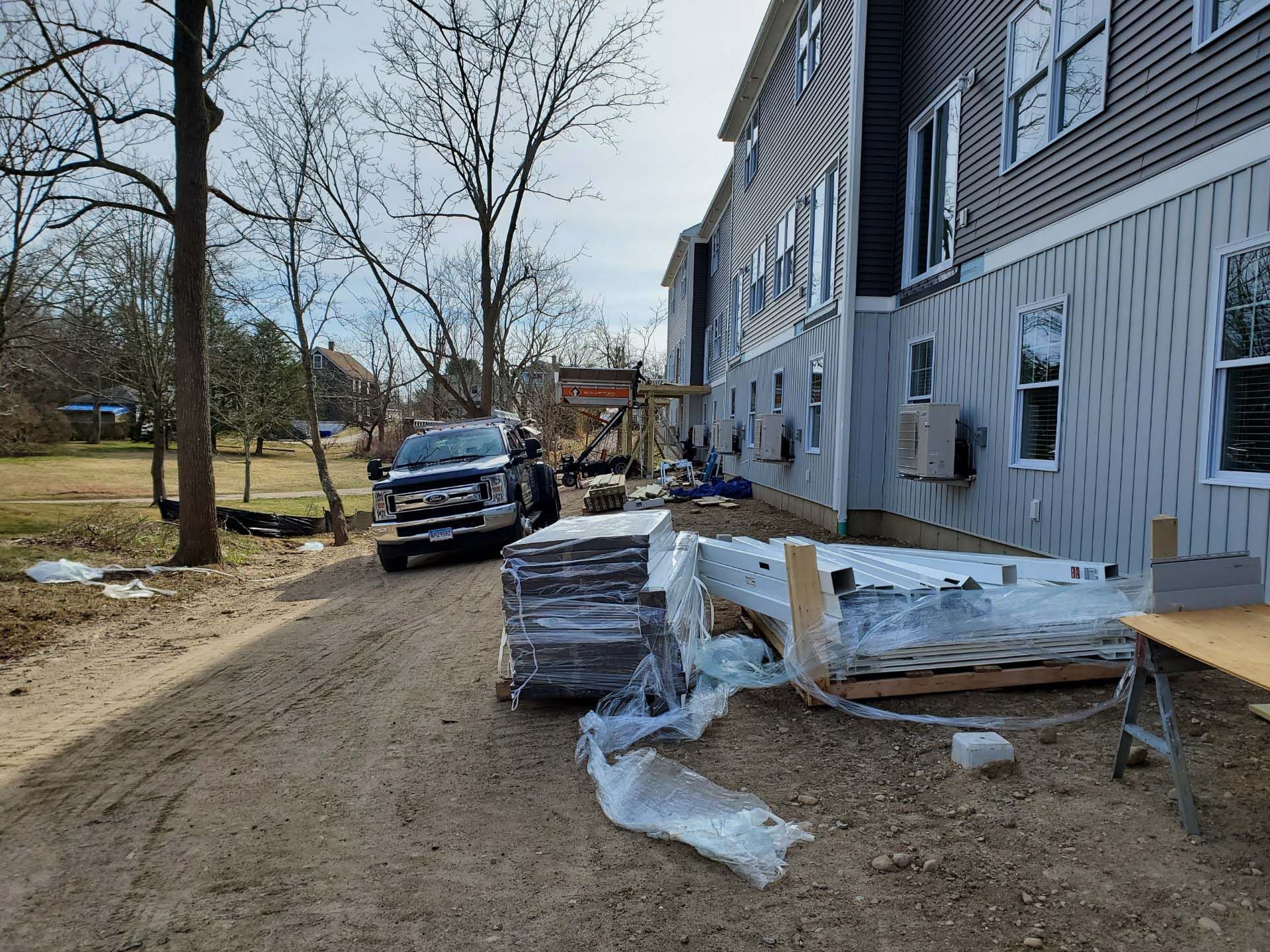A truck is parked in front of a building under construction.