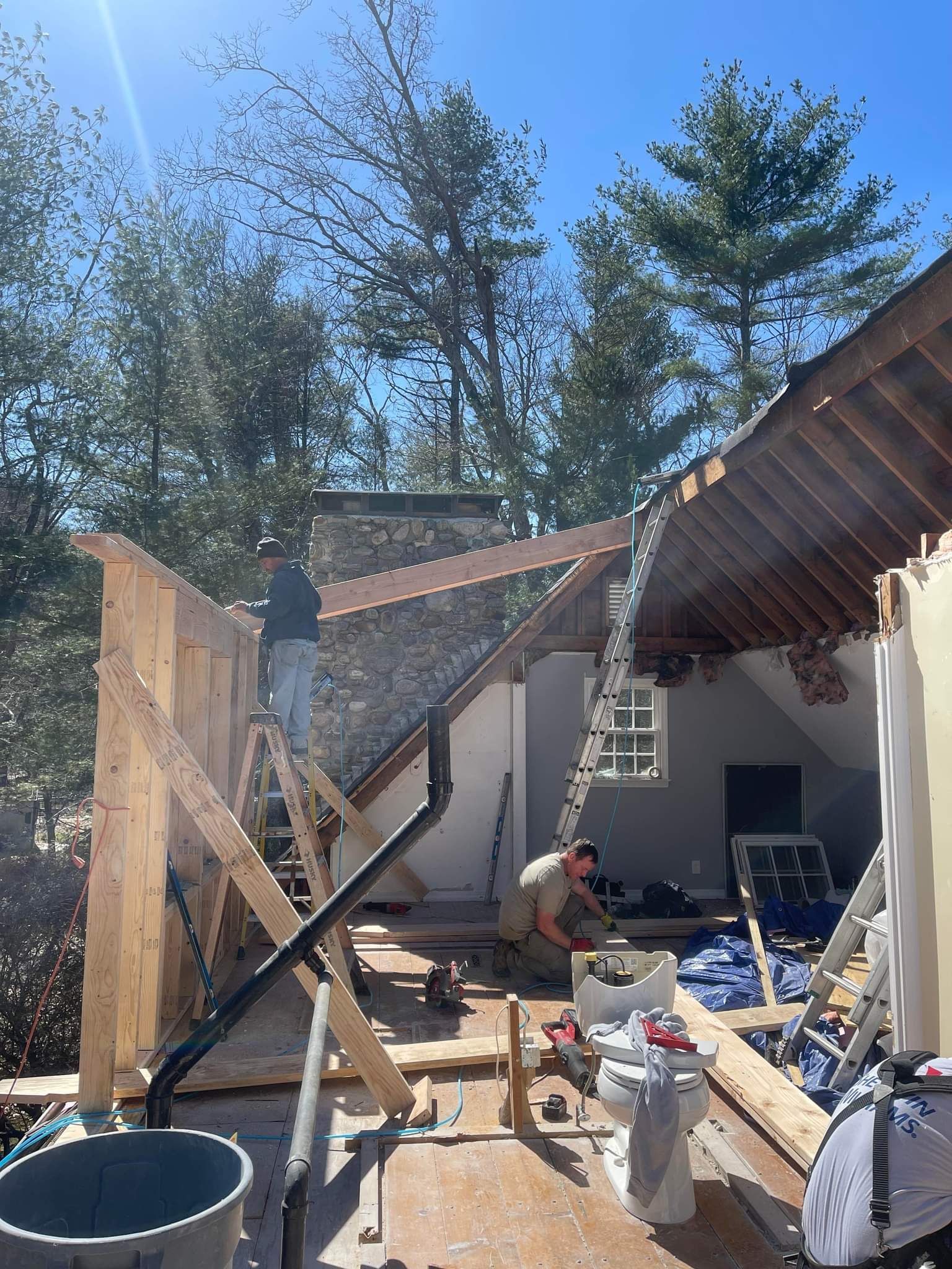 A man is working on the roof of a house.