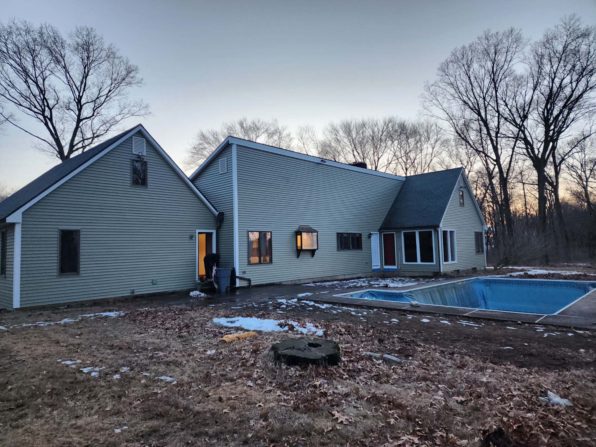 A large house with a swimming pool in front of it