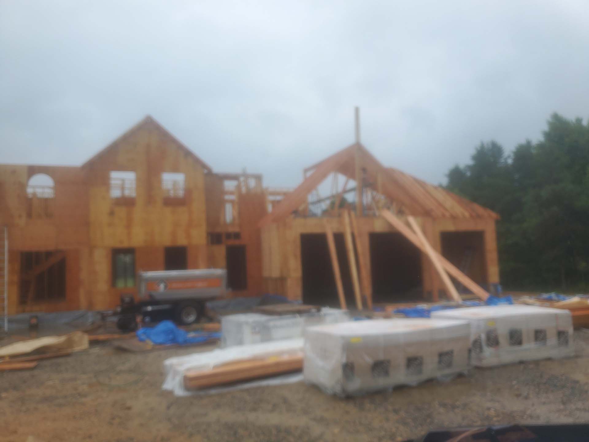 A large wooden house is being built on a cloudy day