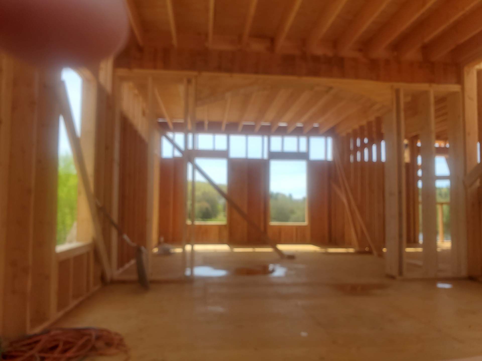 The inside of a house under construction with a lot of windows