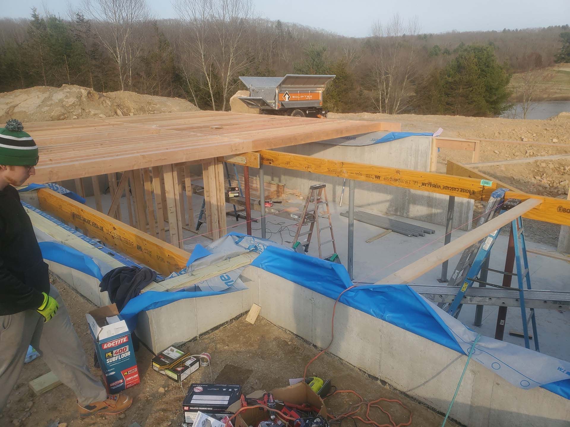 A man is standing in front of a building under construction.