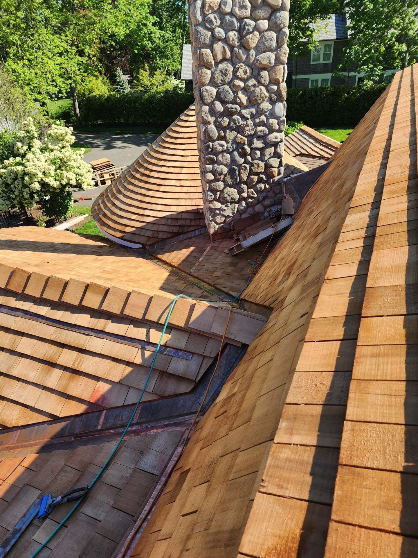 A wooden roof with a stone chimney on top of it.