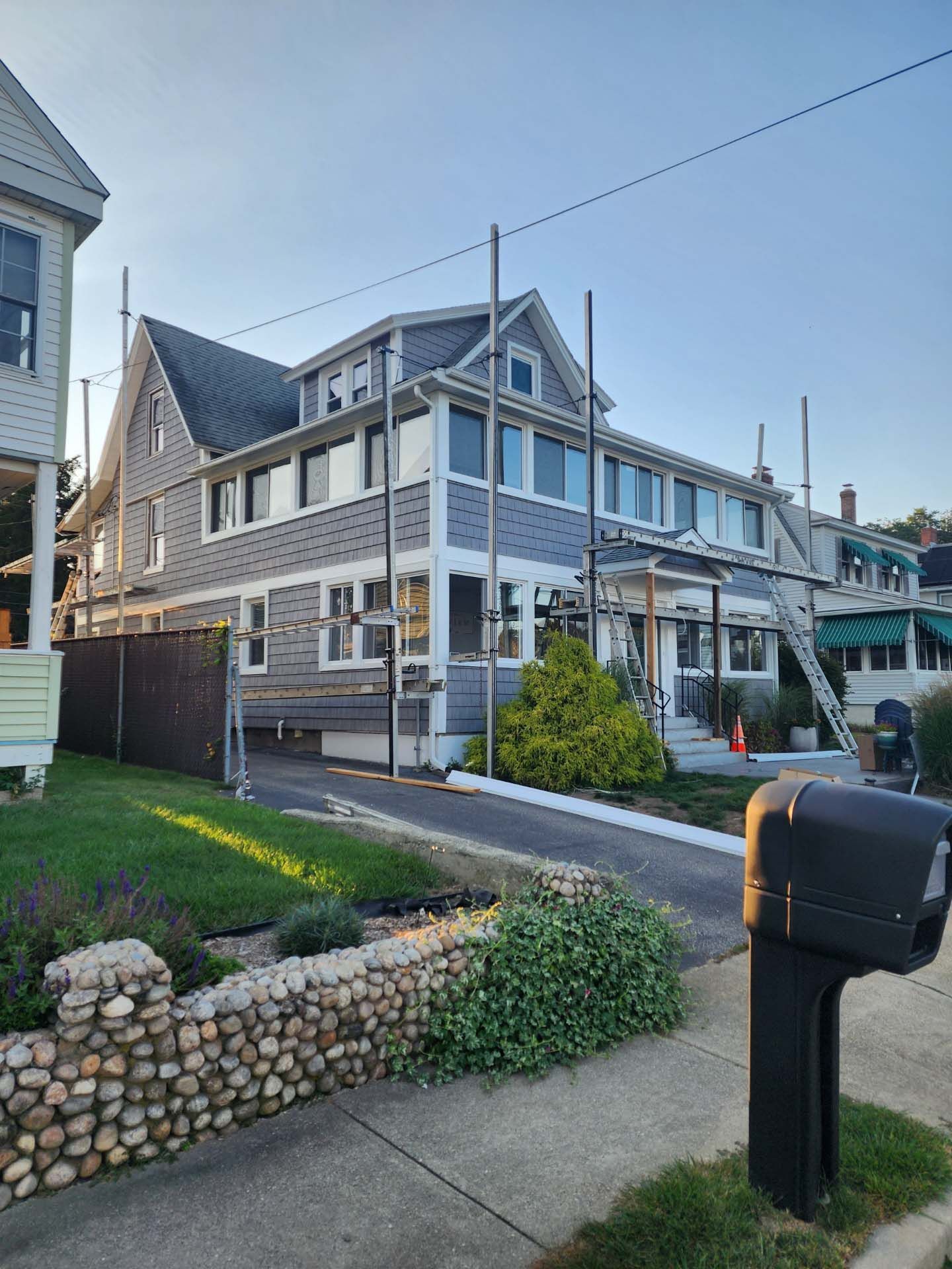 A large house with a mailbox in front of it is being remodeled.
