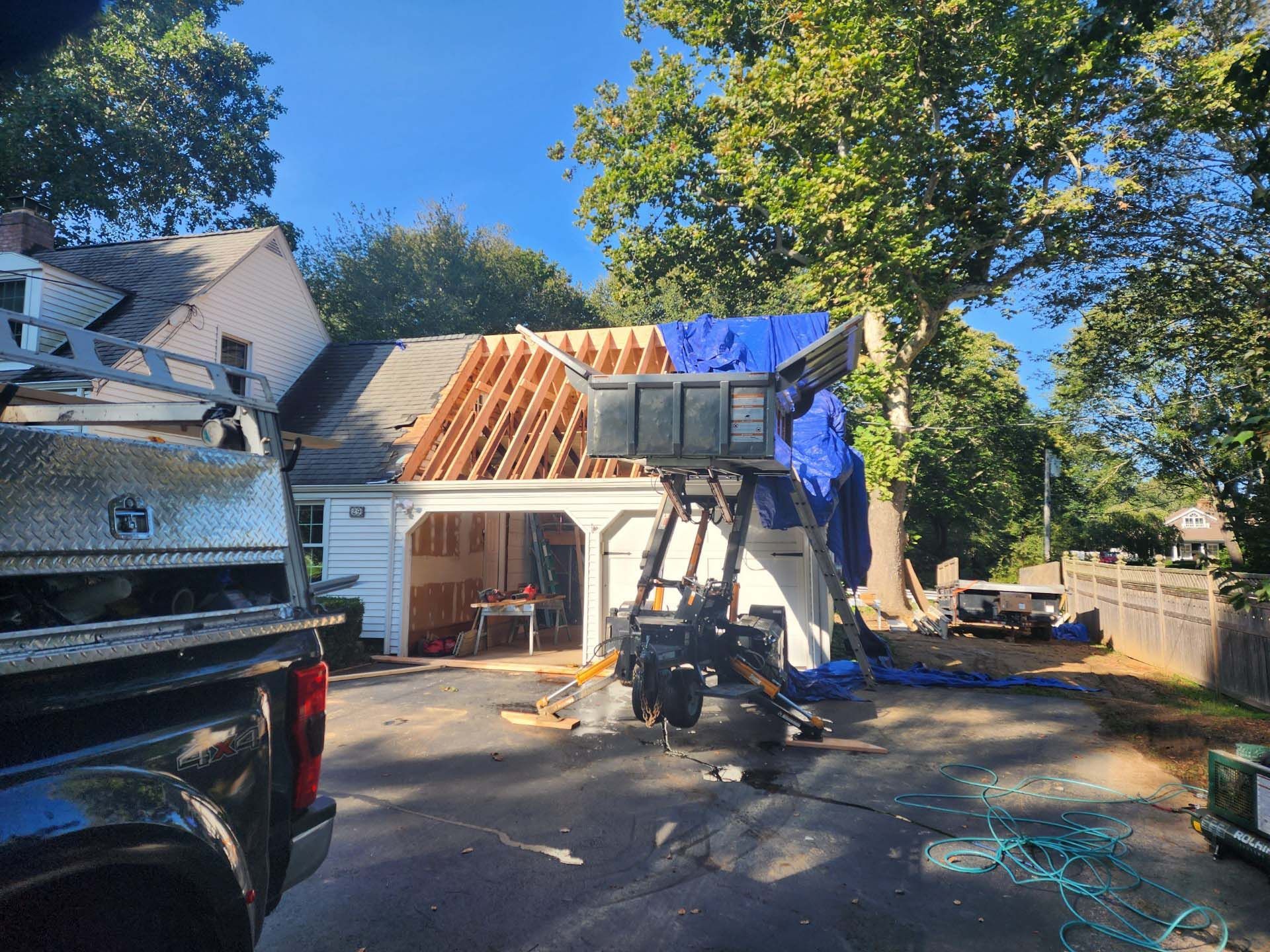 A truck is parked in front of a house that is being remodeled.