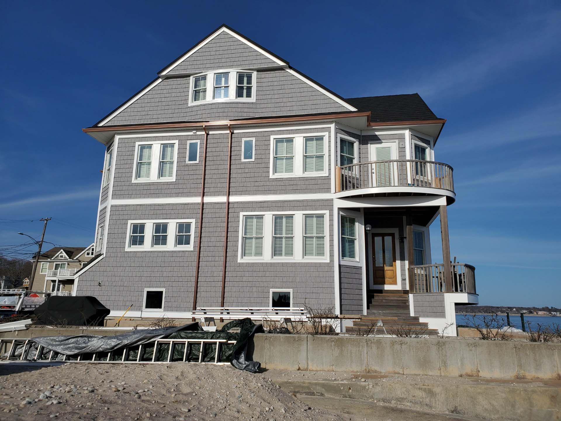 A large house with a lot of windows is on the beach