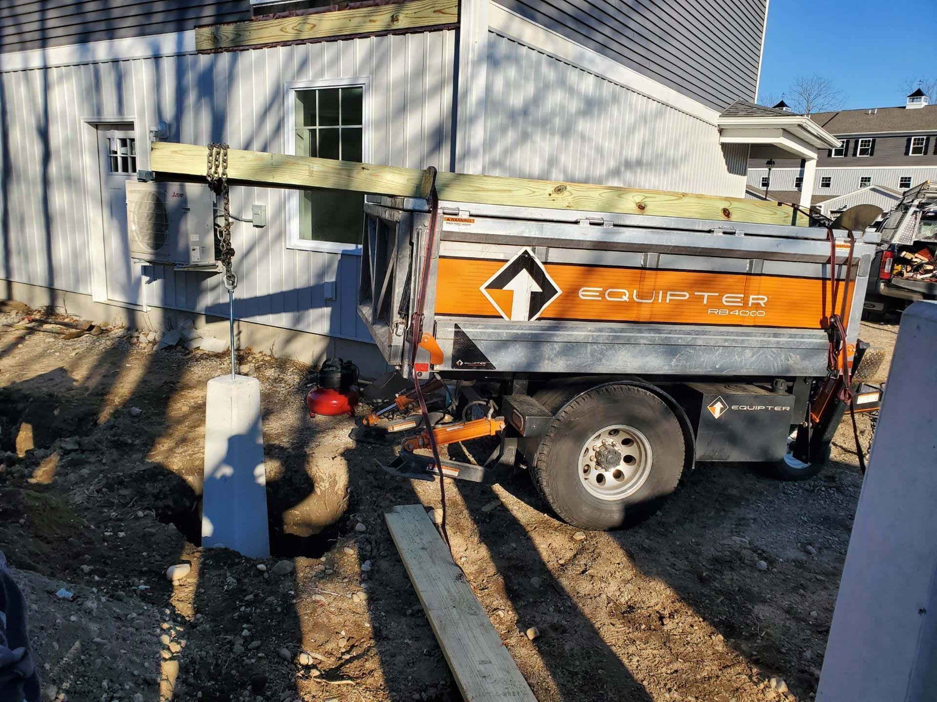 A dump truck is parked in front of a house.