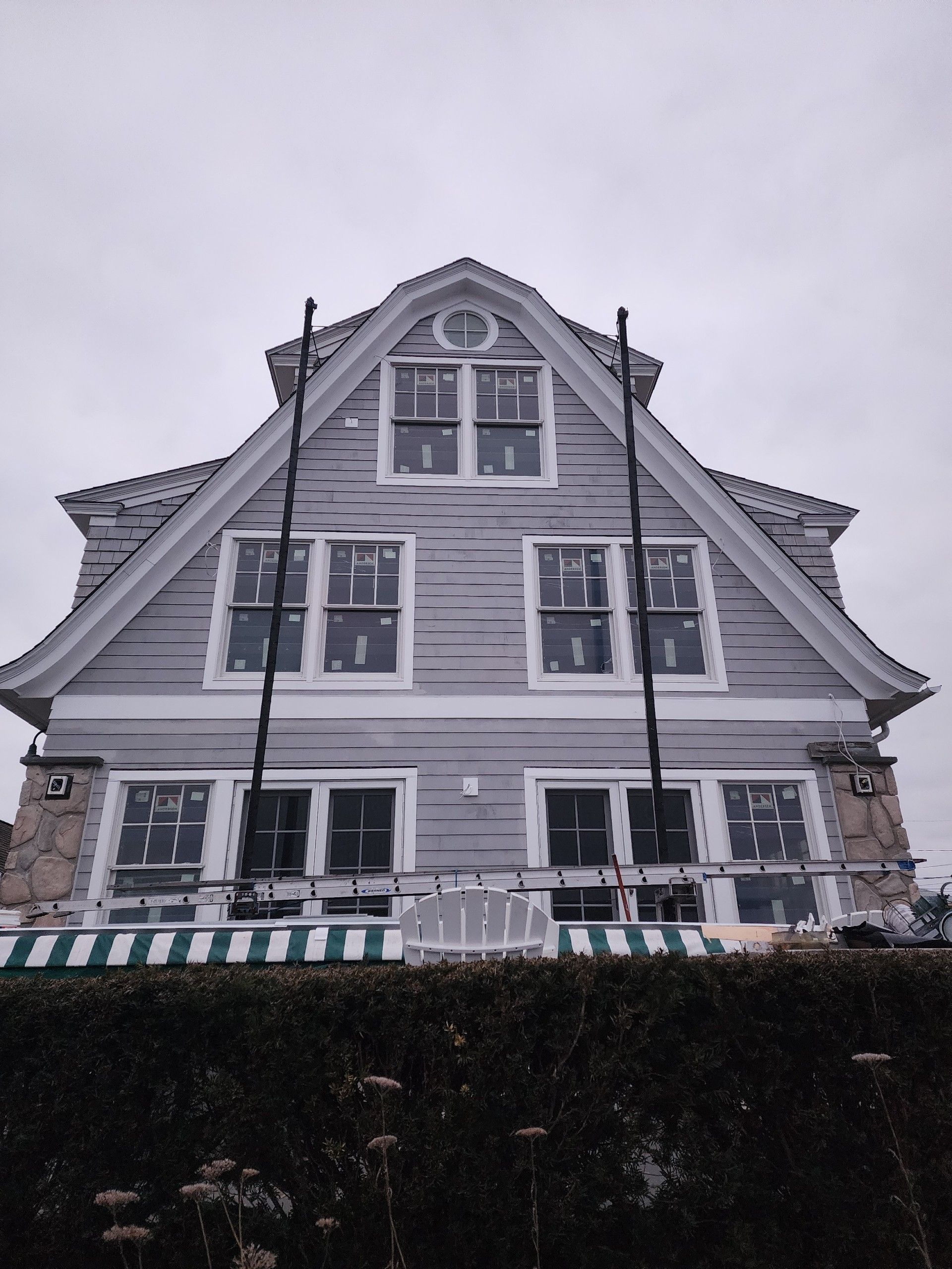 A large house with a lot of windows is being remodeled