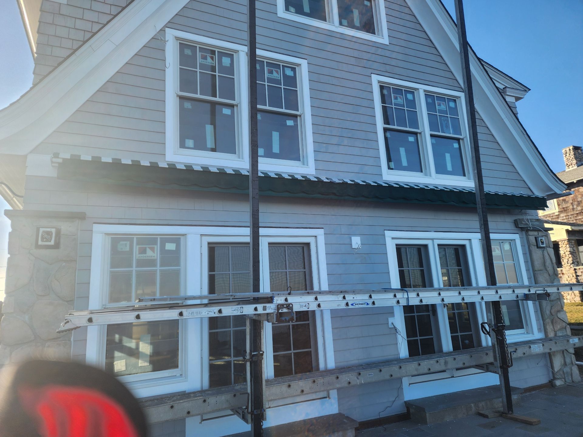 A house with a ladder on the side of it.