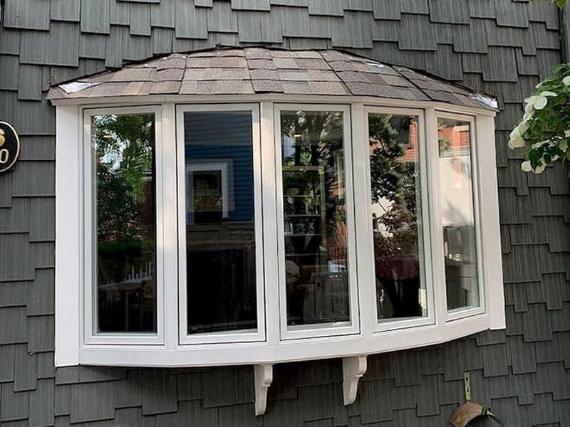 A large boy window on the side of a house.