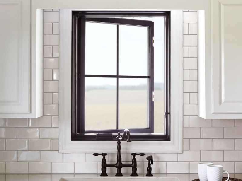 A kitchen sink with a black window above it