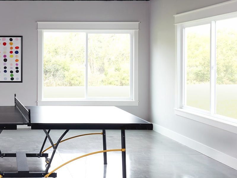 A table in a room with lots of windows