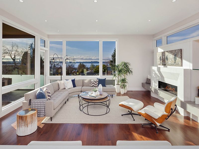 A living room with a couch , chair , coffee table and fireplace.