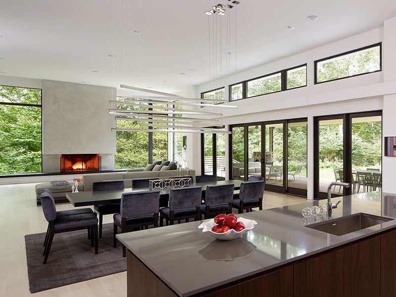 A kitchen with a dining table and chairs and a fireplace