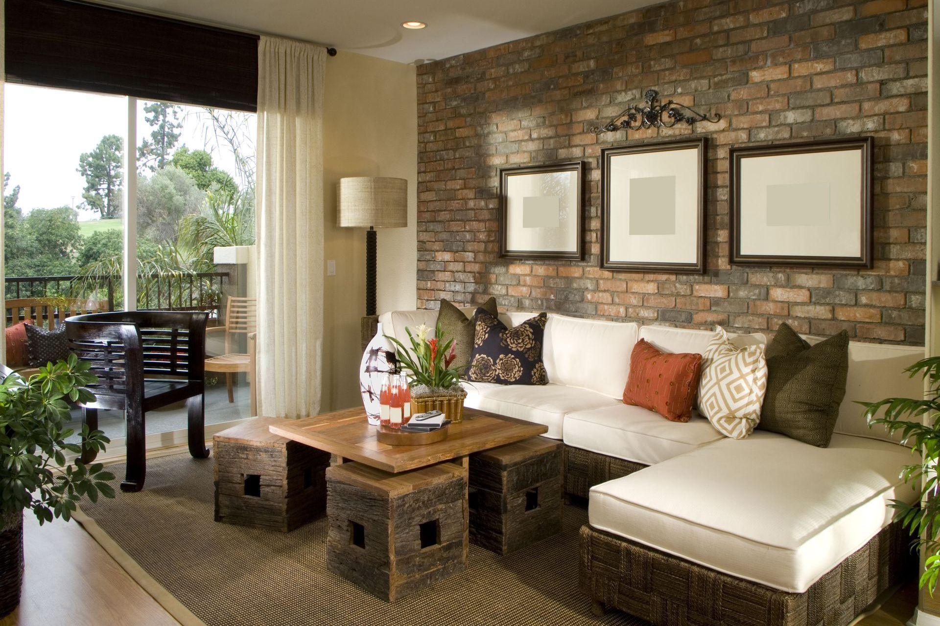 A living room with a brick wall and wicker furniture