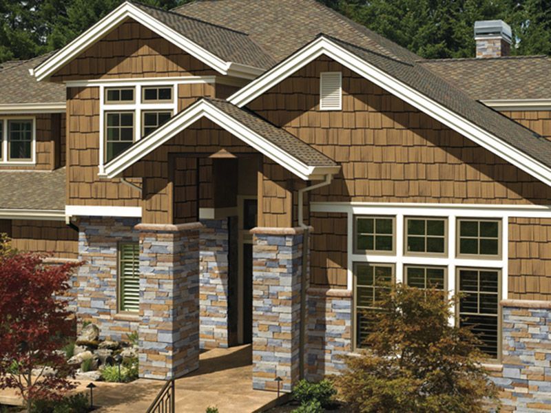 A large house with a lot of windows and a roof