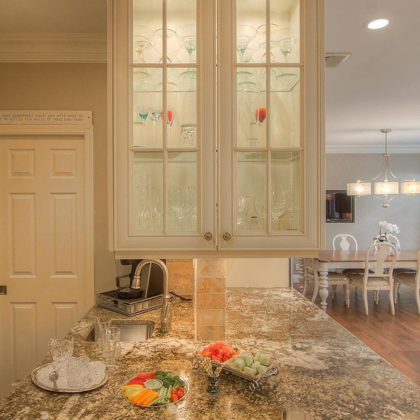 Kitchen with cabinets and countertop; dining room visible in background.
