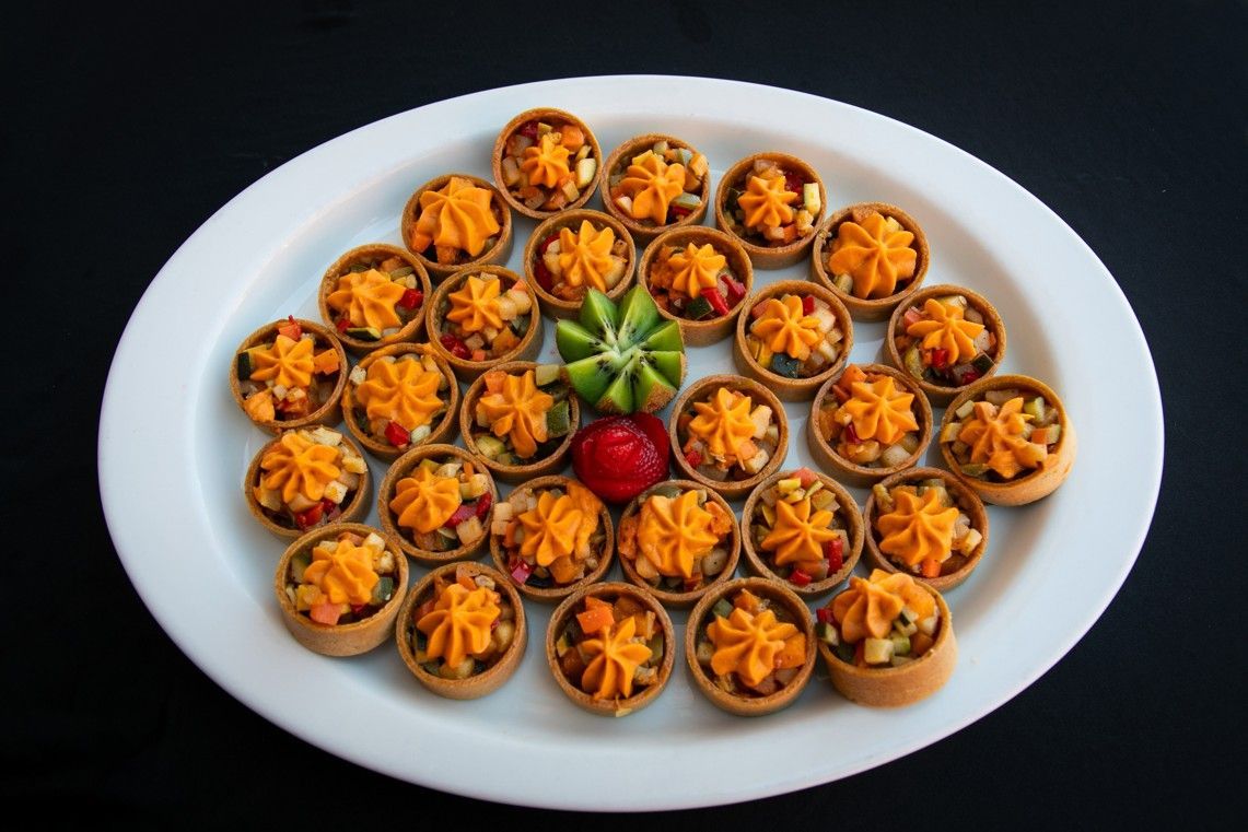 A plate of food with a strawberry in the middle