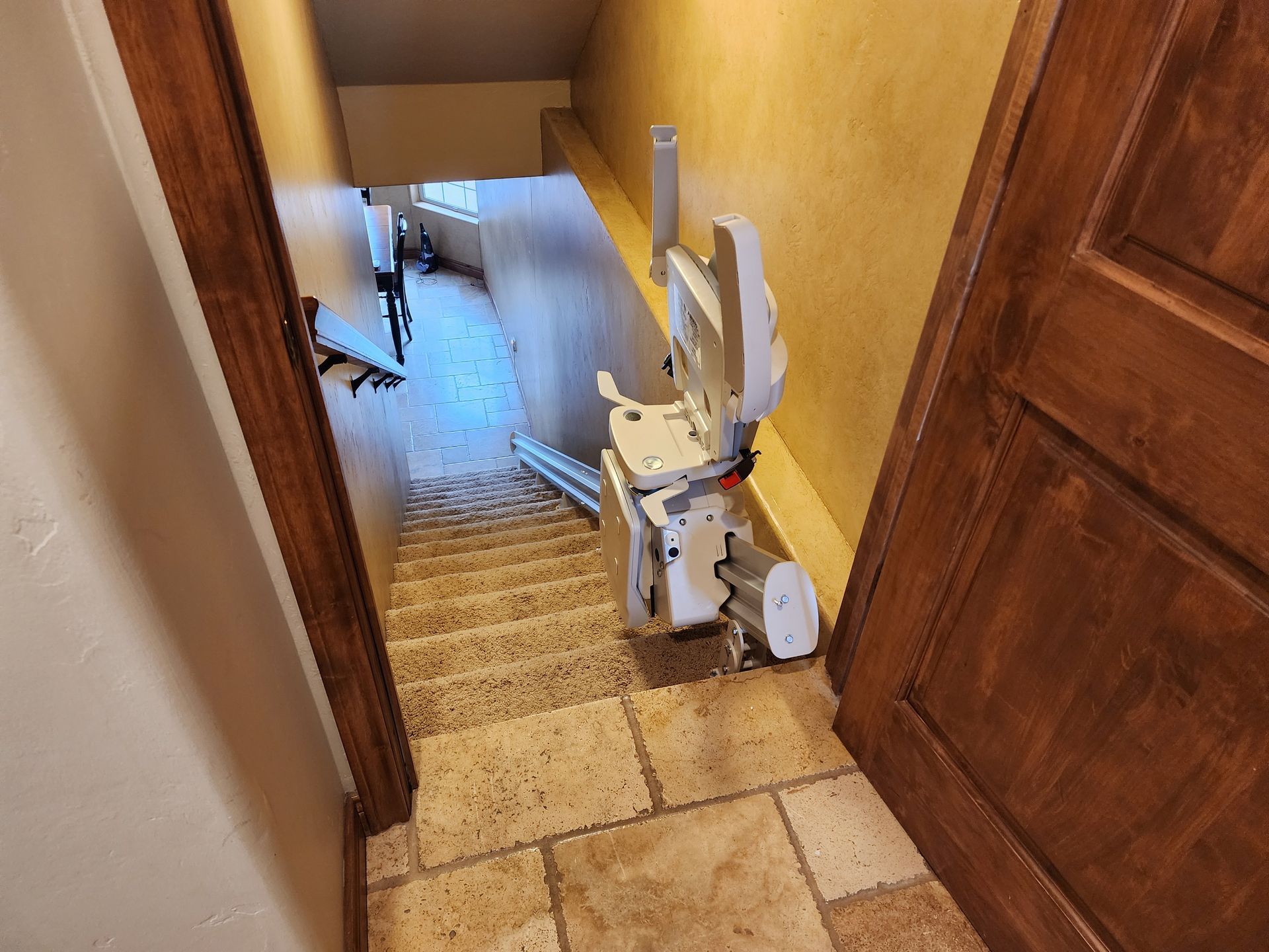 a stair lift is sitting in a hallway next to a door.