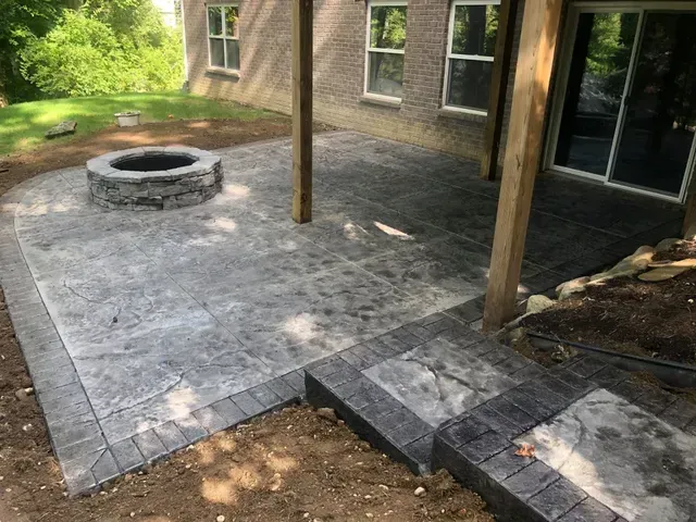 There is a fire pit in the middle of the patio.