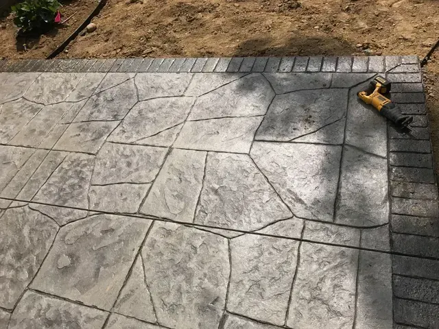 A concrete patio with a drill on top of it.